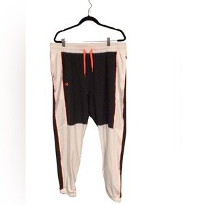 Under Armour Mens Icon Woven Track Pants in black and white with orange accents